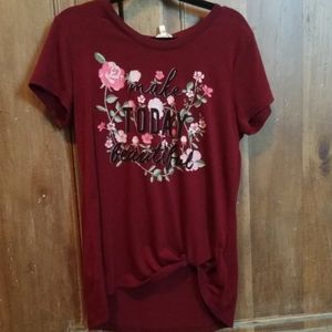 Maroon top with floral pattern.